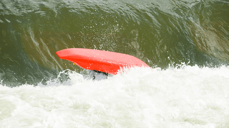 A kayak toppled over in the waves.
