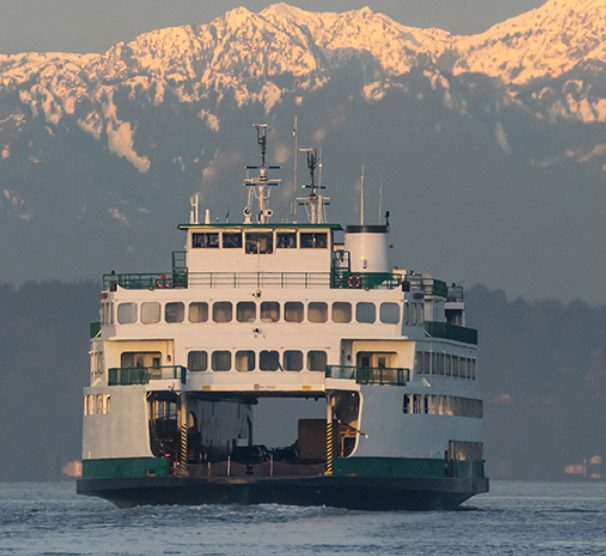 A ferry sailing to an island in the distance.